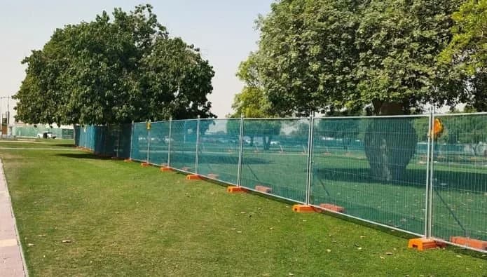 Green temporary security fencing installed along a site perimeter