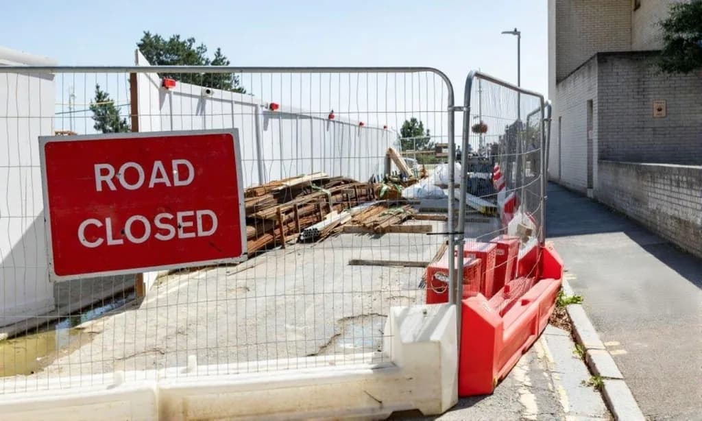 Temporary site fencing and hoarding around an active work area