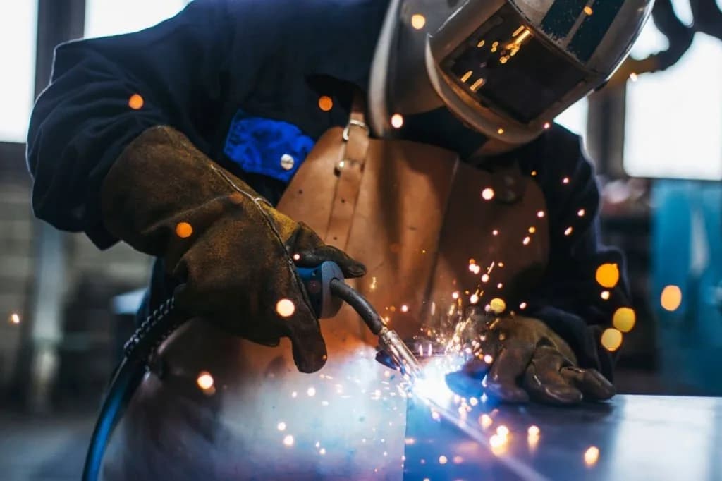 Close-up of a welder joining structural steel